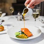 Fine,Dining,Image,Of,Pouring,Sauce,Over,Salmon,Dish